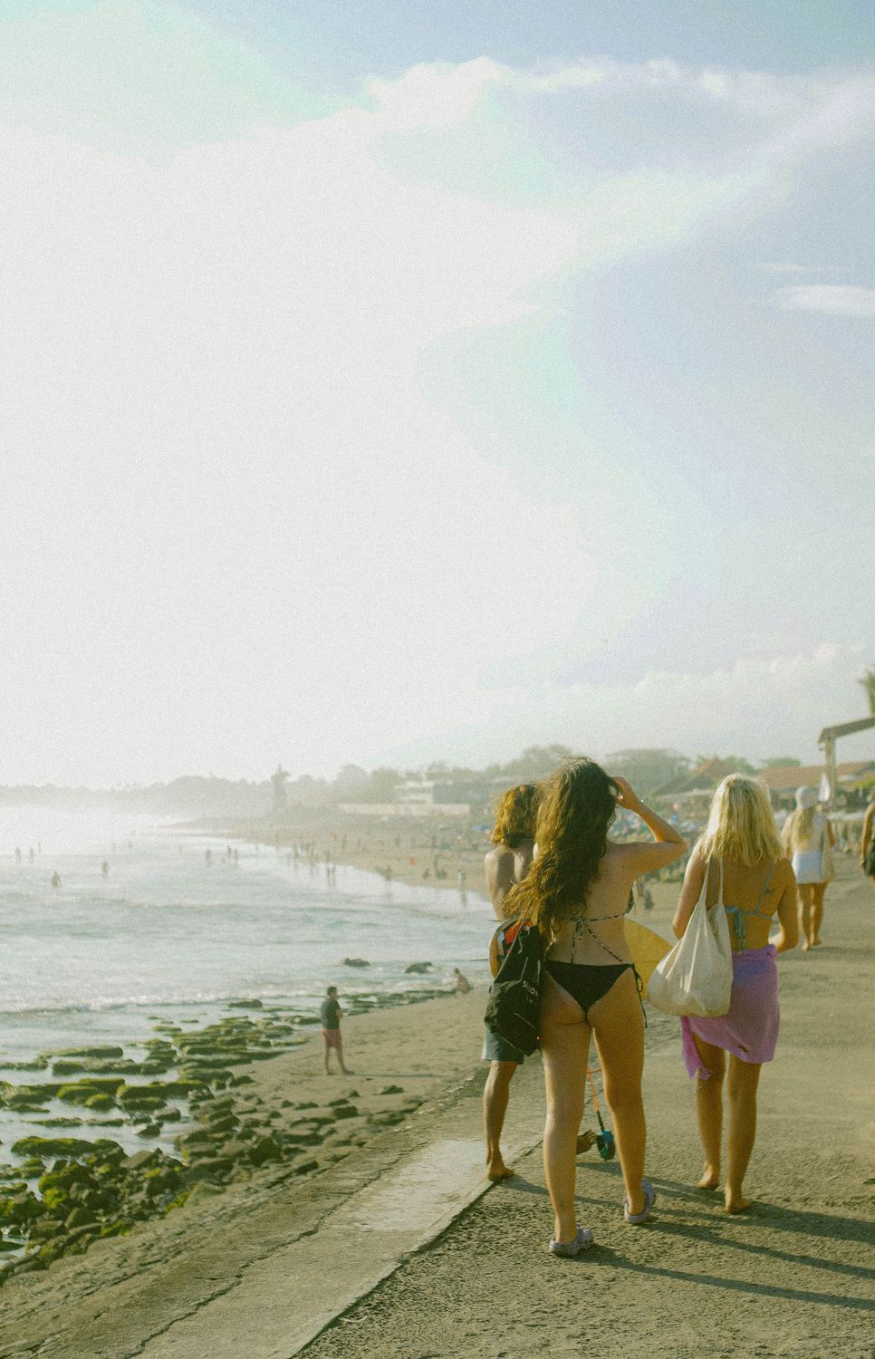 Friends walking along a Canggu beach